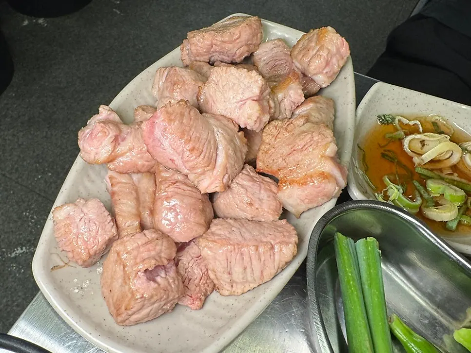 Staff grilling pork neck on the charcoal grill