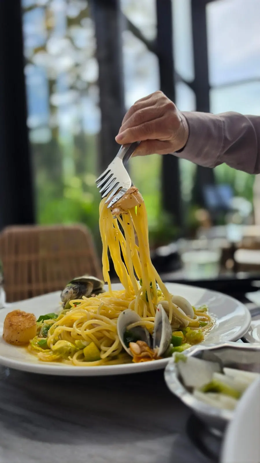 Scallop oil pasta on the table with the space in the background