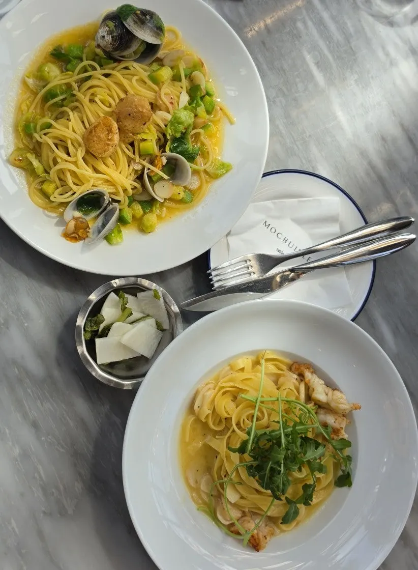Table setting with two pastas shared between friends