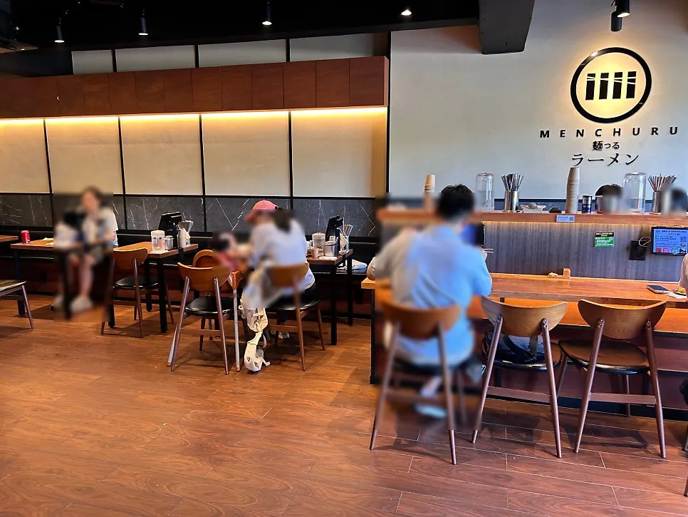 Interior of the ramen restaurant with tables spaced widely