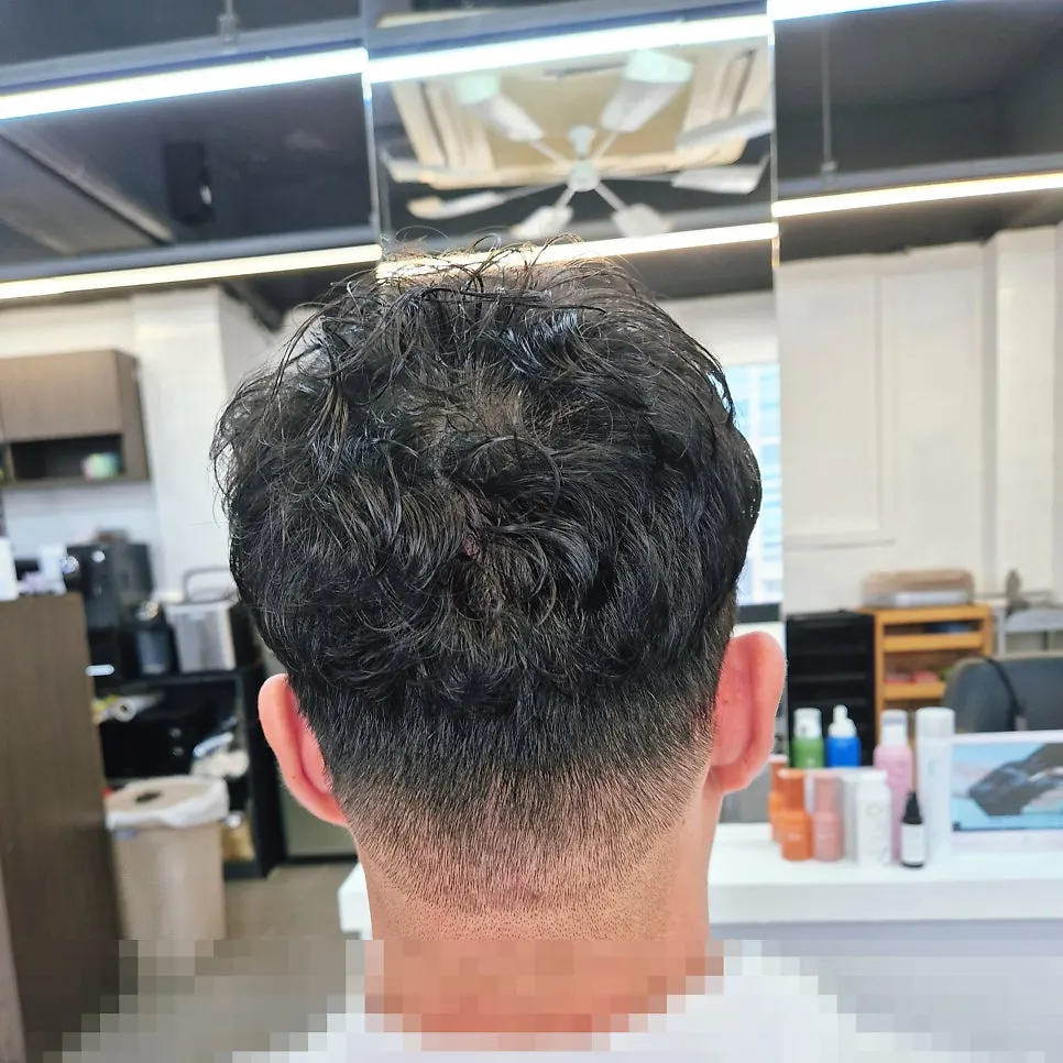 Crown volume perm being applied to the top of the hair