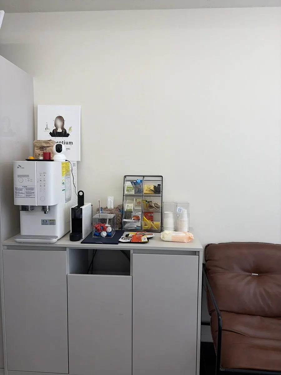 Waiting area with snacks, tea bags, and a water dispenser