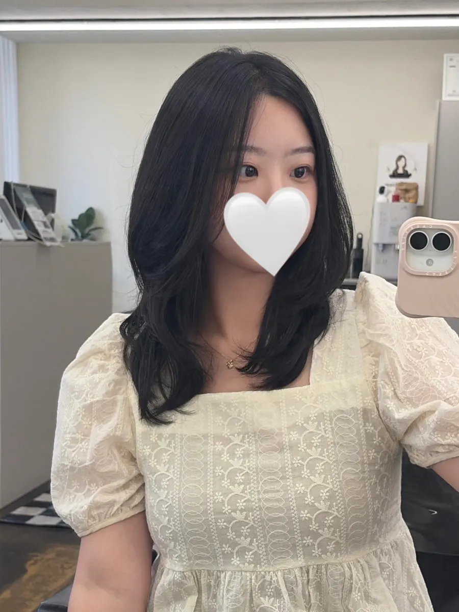 Layered perm style with volume brought out at the sides