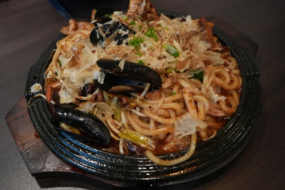 A plate of soy-sauce-based seafood yaki udon