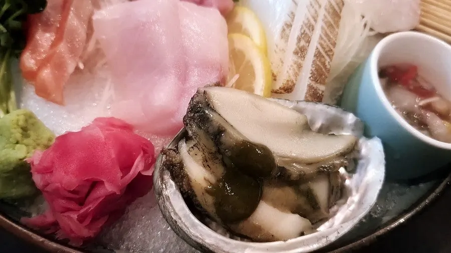 Steamed abalone served with the mixed sashimi