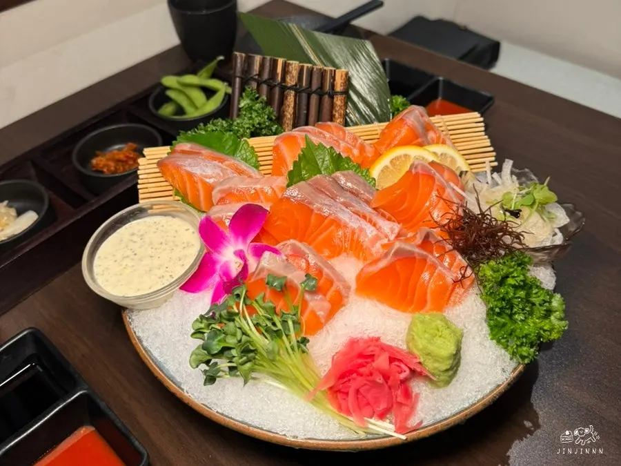 Picking up a piece of salmon sashimi