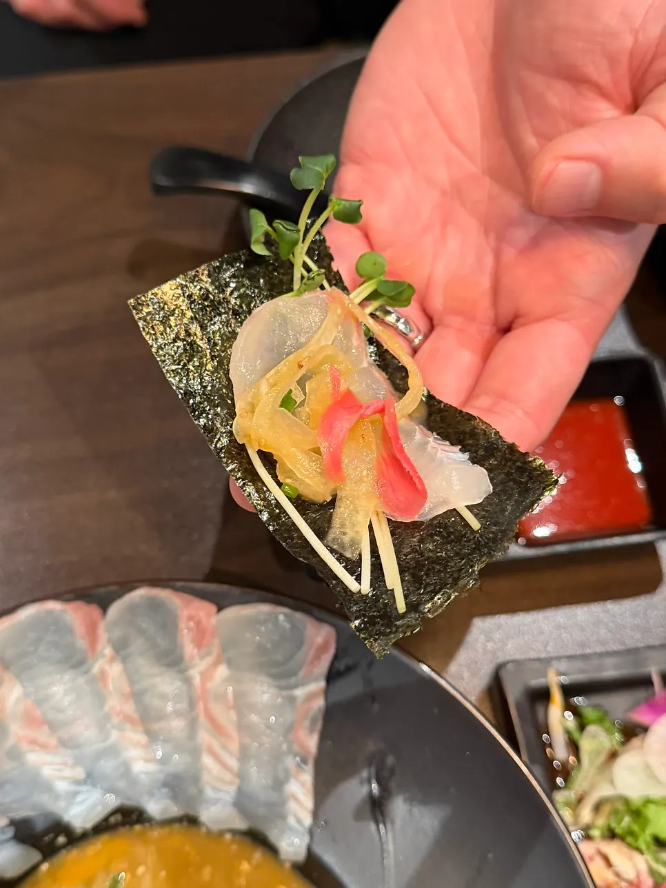 Wrapping sashimi and radish sprouts in seaweed