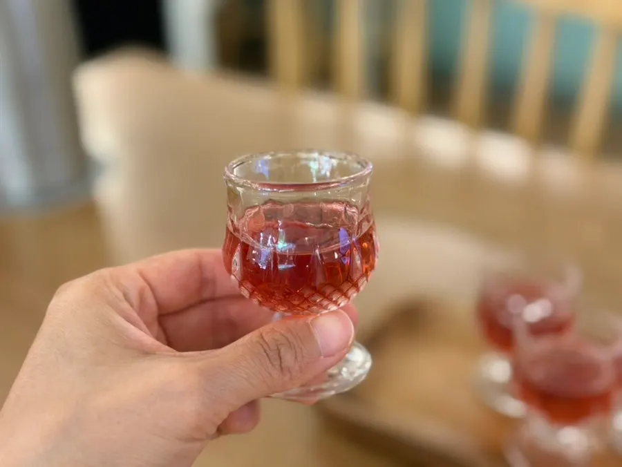 A glass of omija tea sipped while waiting for food