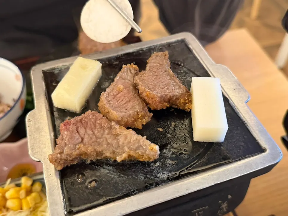 A golden-grilled piece of gyukatsu with sauce