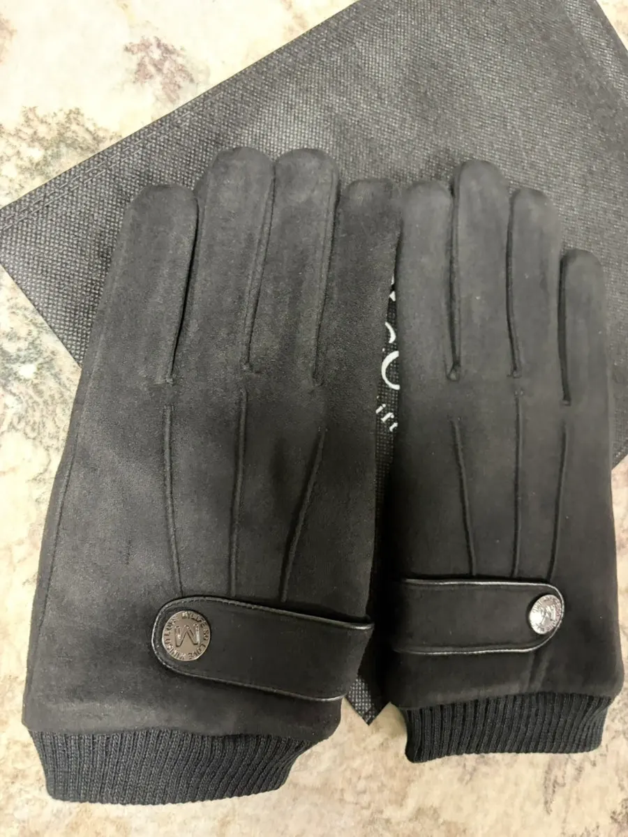 Black gloves worn with a coat