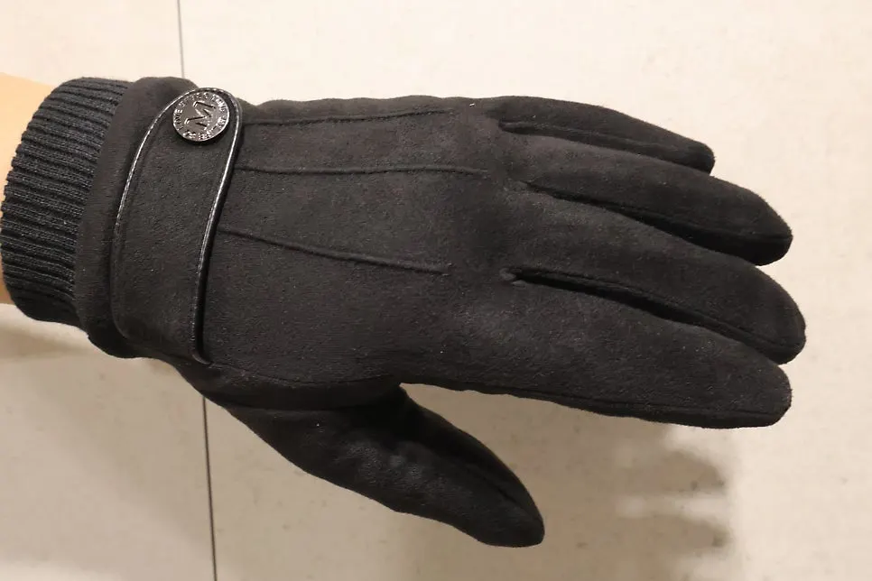 Hand wearing men's gloves