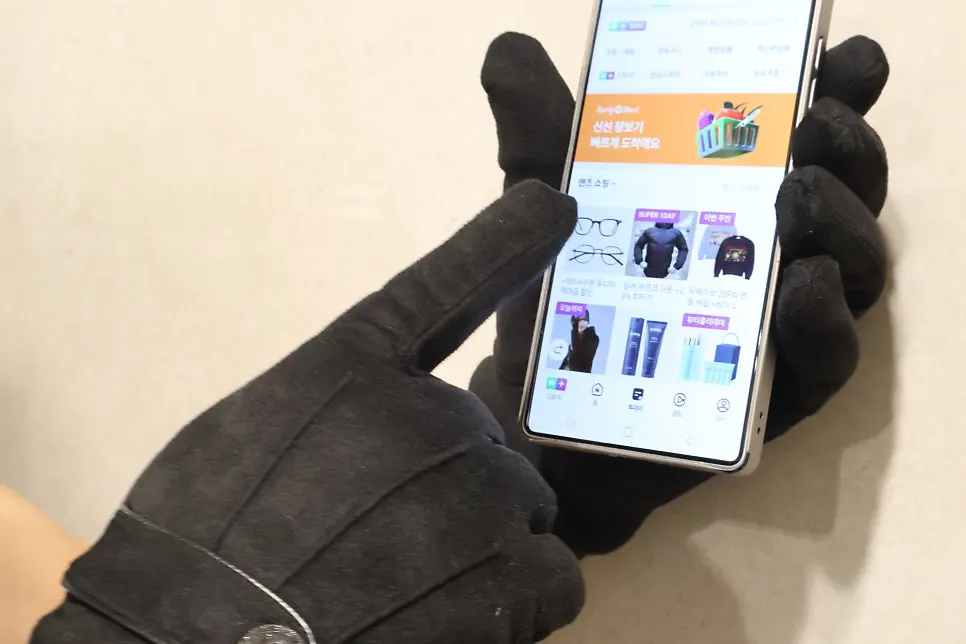 Gloved hand using a smartphone
