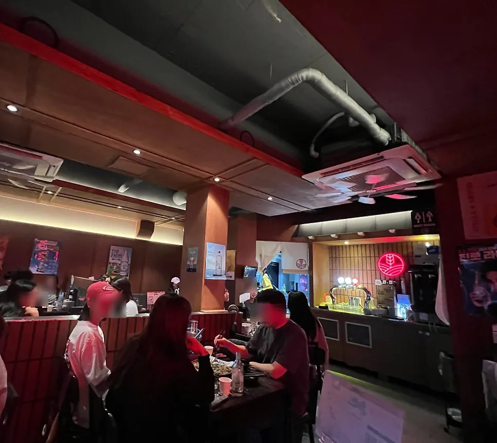 Interior hall with red lighting and neon signs