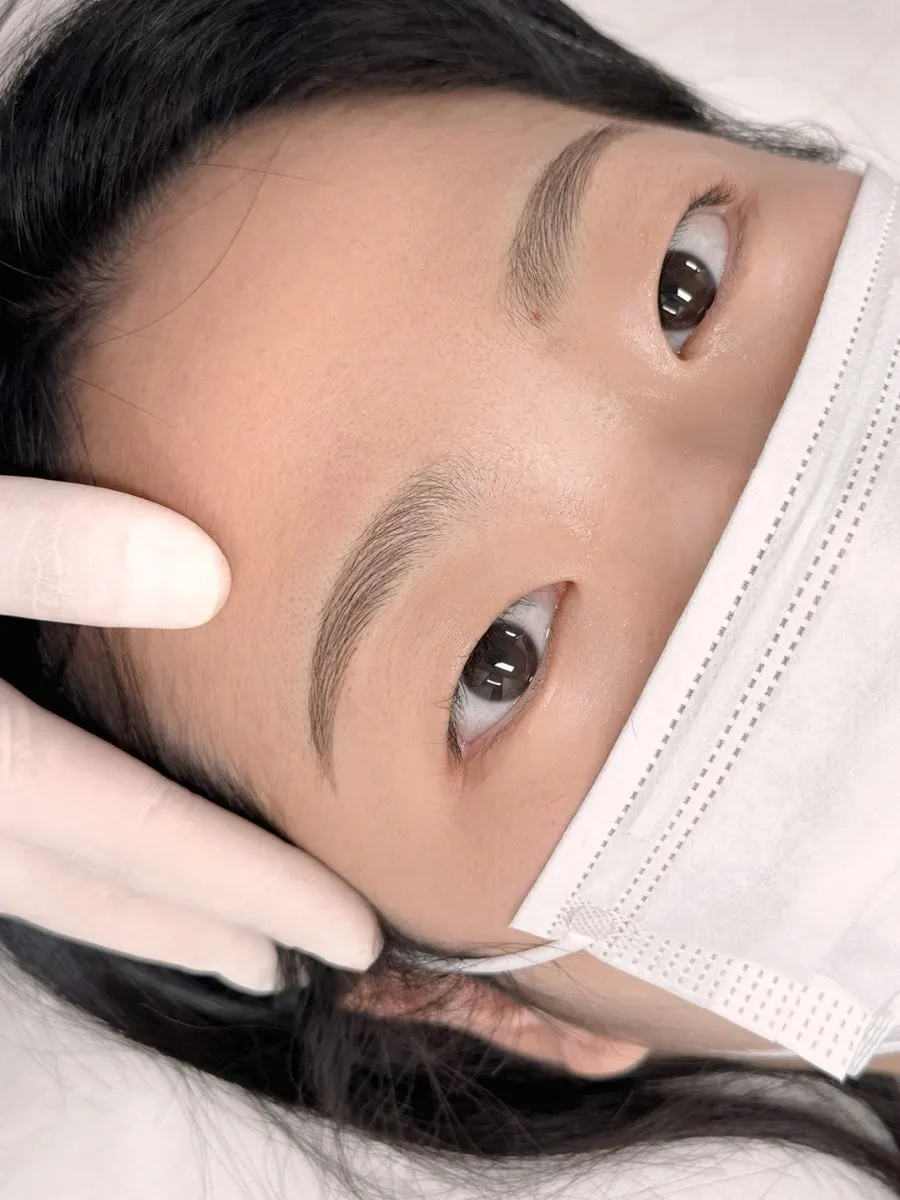 Completed eyebrow design covering the scarring