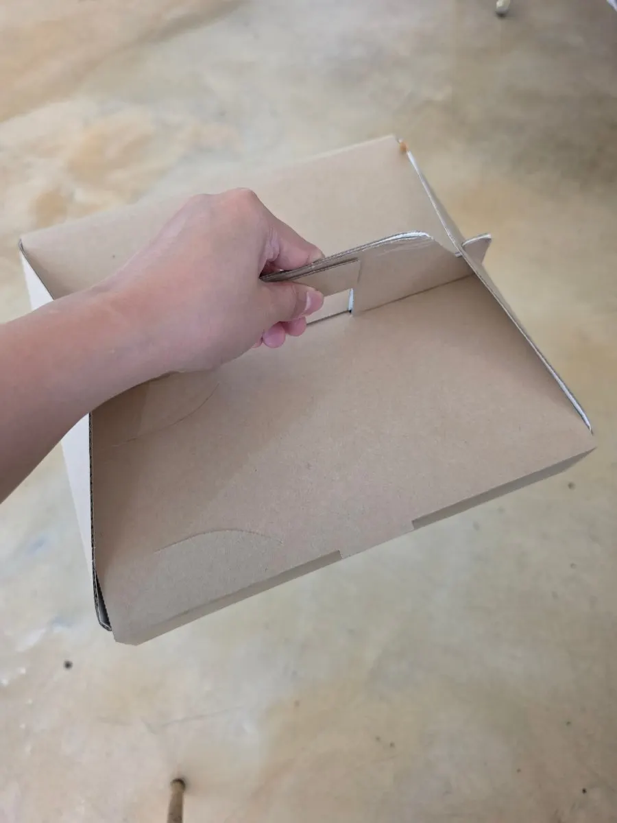 Three leftover slices of wood-fired pizza packed to go