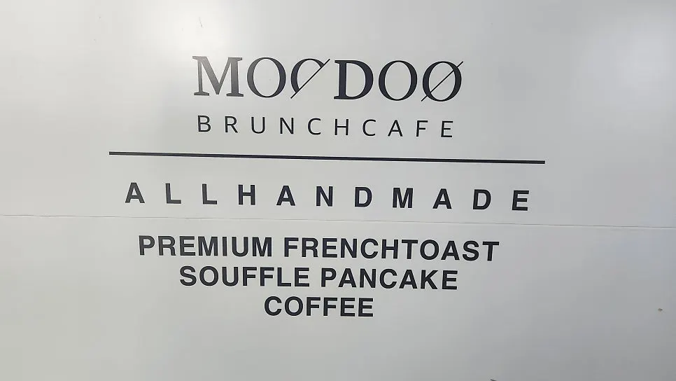 Storefront entrance with the MOODOO sign