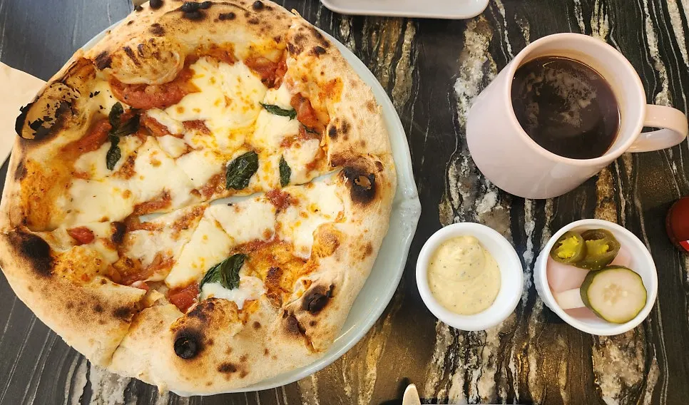 Wood-fired margherita pizza cut into six slices