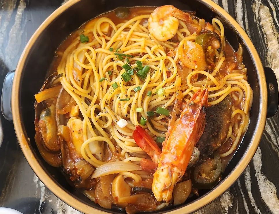 Pescatore pasta topped with shrimp and mussels