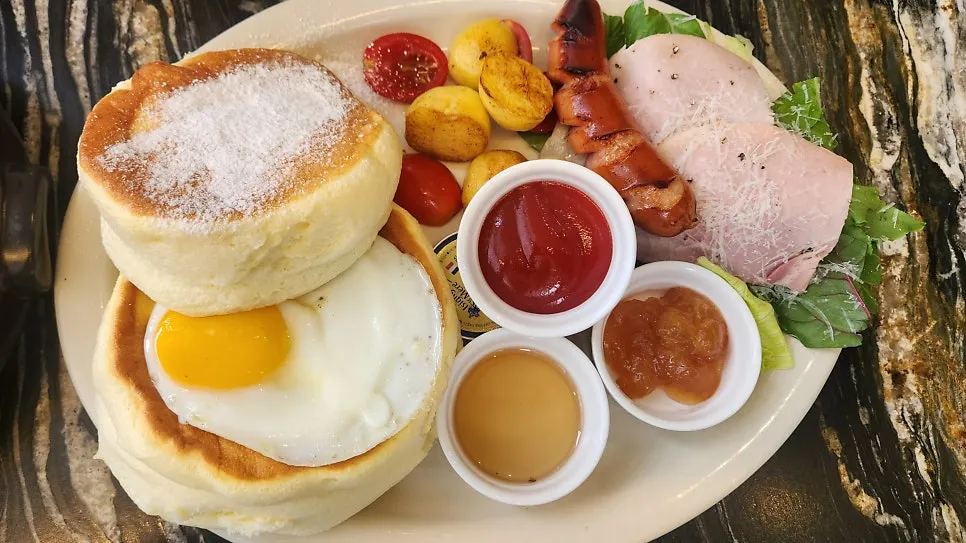 Brunch plate with roasted baby potatoes, sausage, and a soft-boiled egg