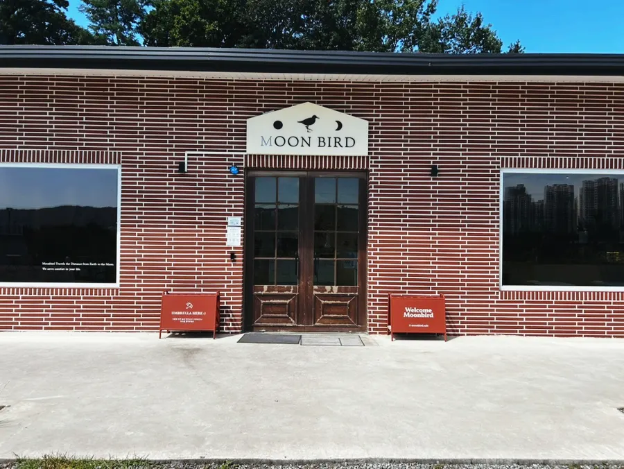 Exterior of Moonbird café with its lawn garden
