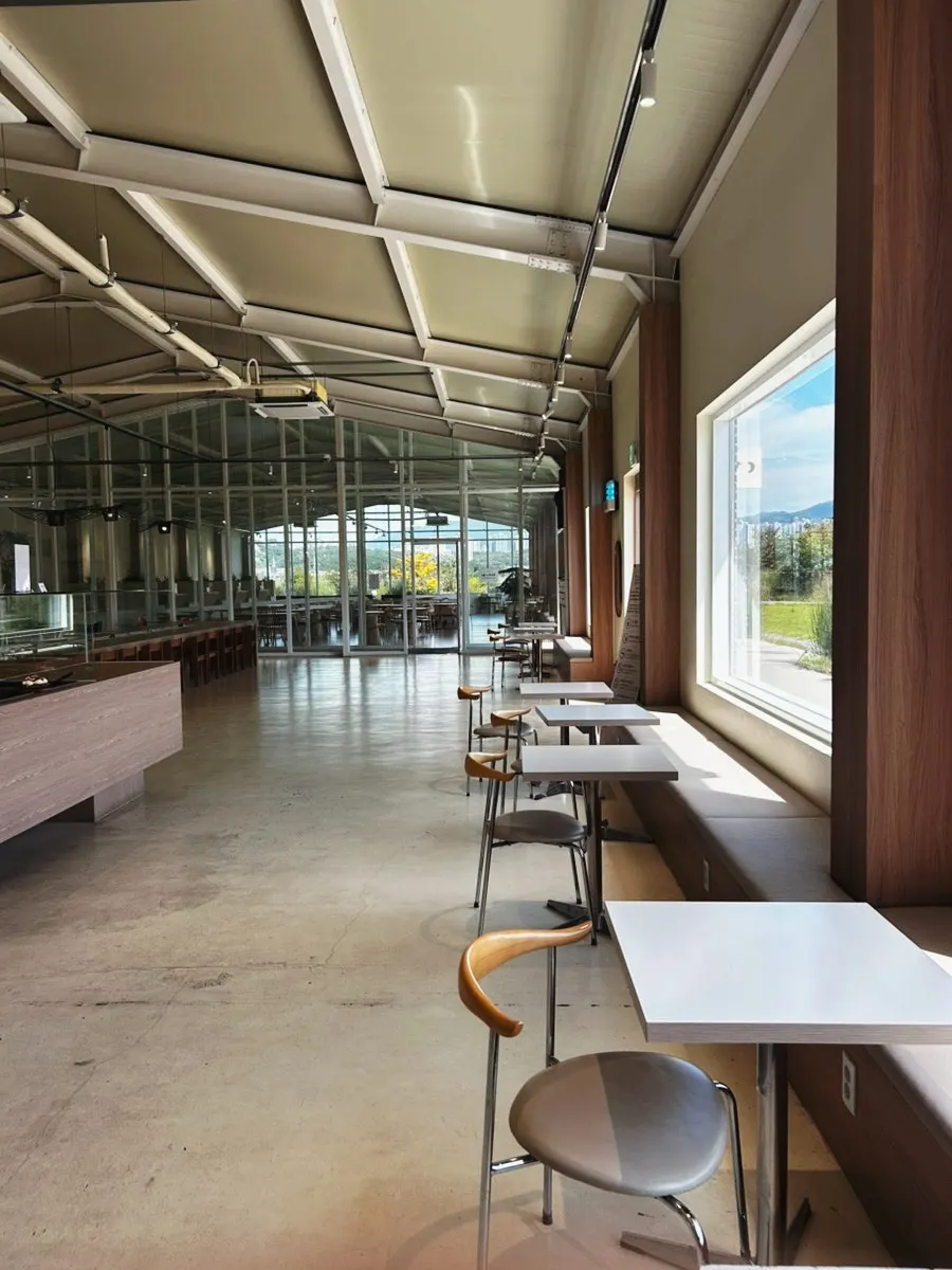 Beige-toned interior of Moonbird's A-hall with floor-to-ceiling windows