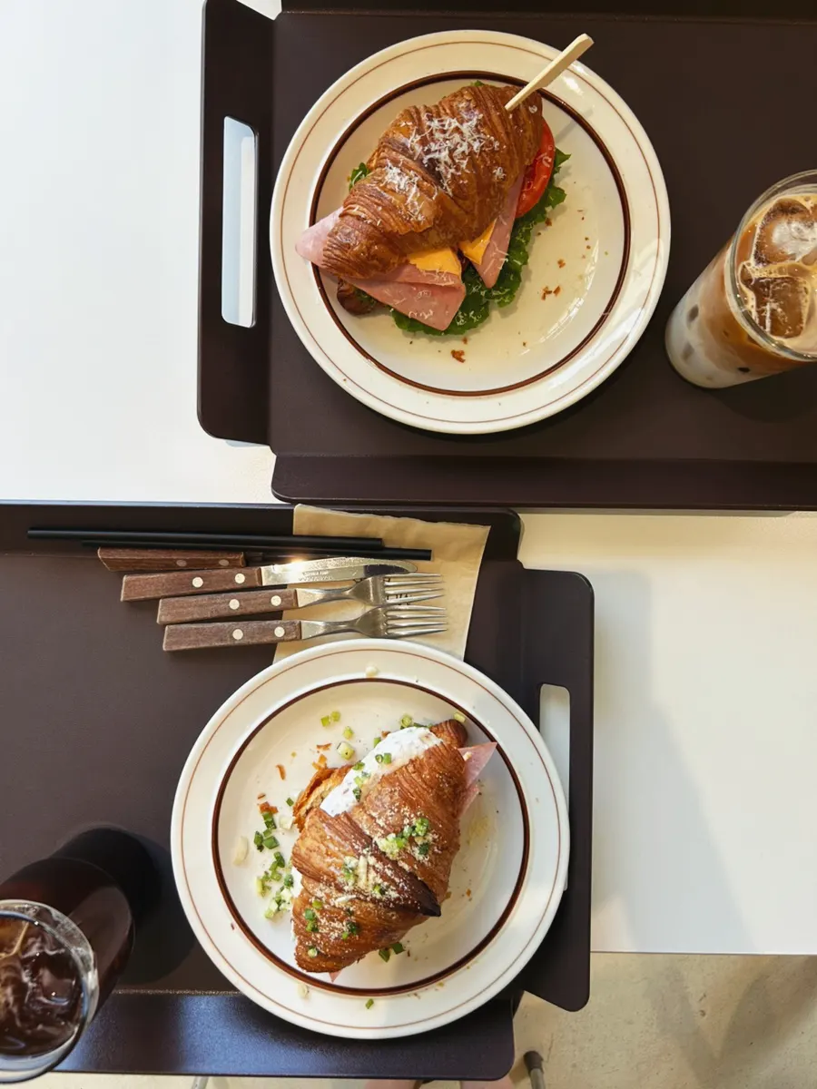 Croissant sandwich and coffee spread at Moonbird