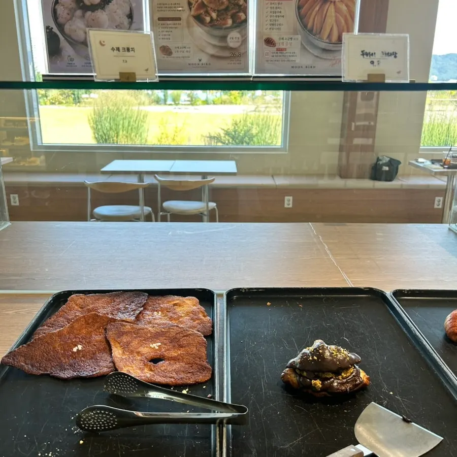 Salt bread and croissants in the bakery case at Moonbird