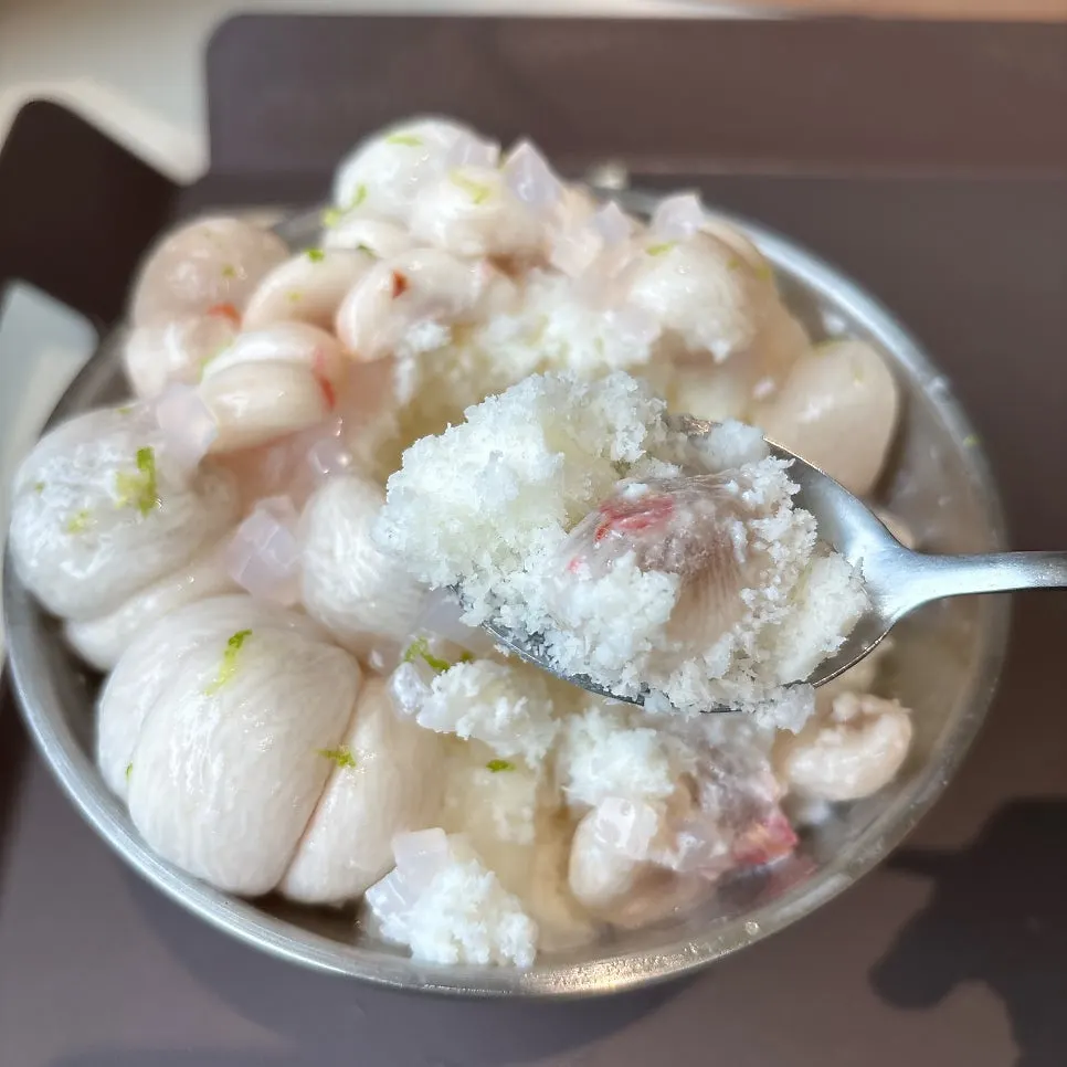 Half-peeled fresh mangosteen on top of milk shaved ice