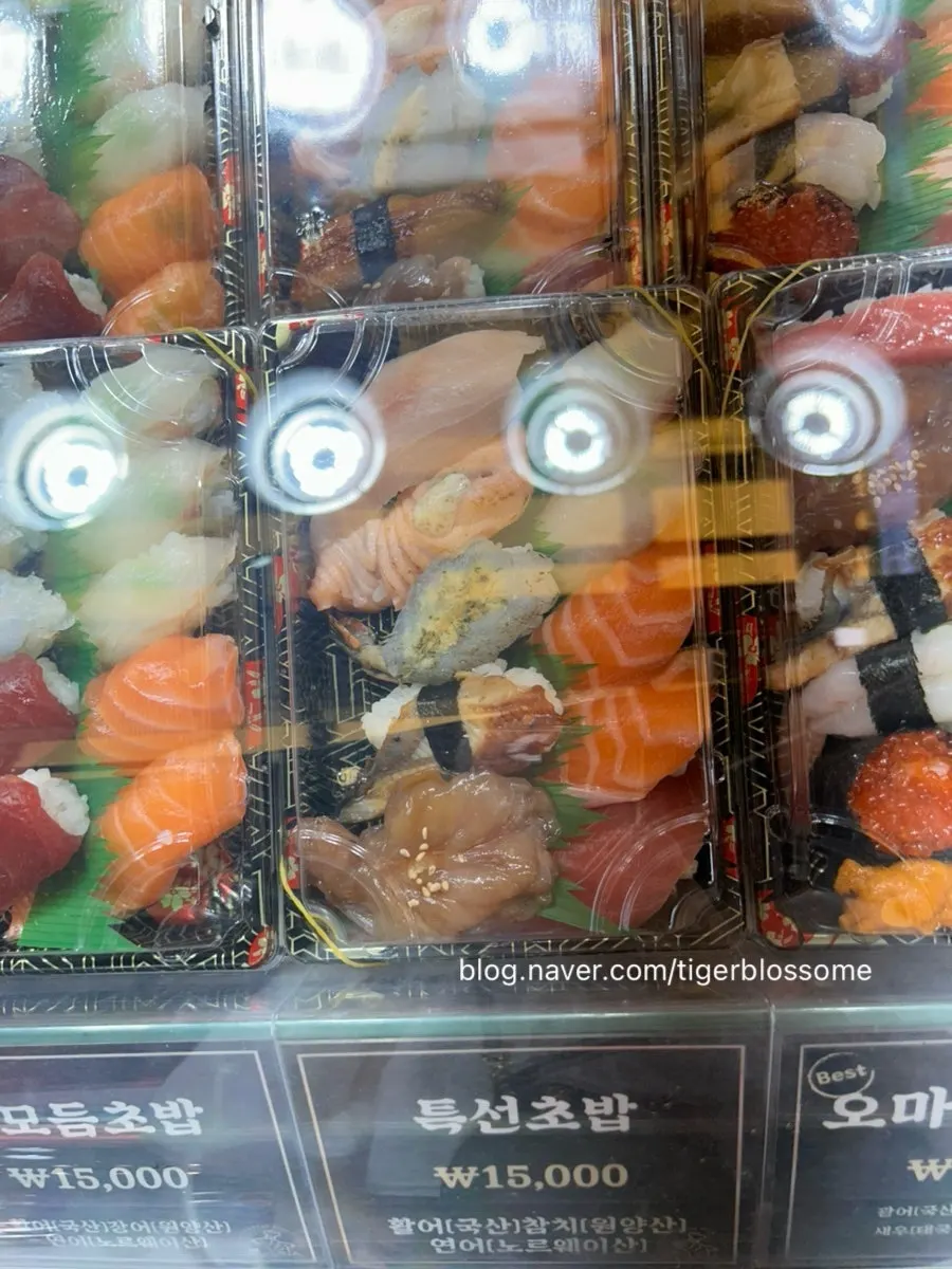 Various sushi displayed in a refrigerated showcase