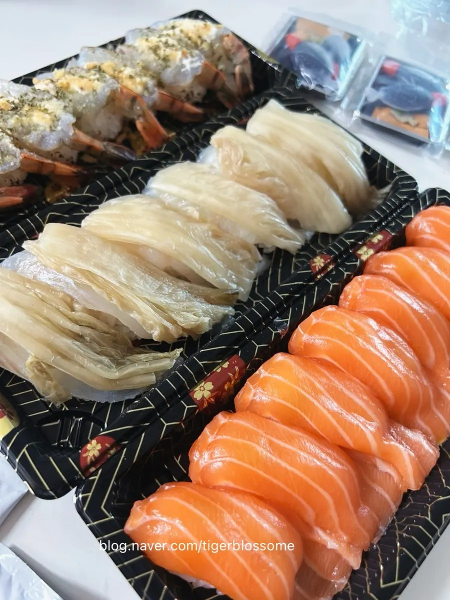 Meal spread of garlic shrimp, aged-kimchi halibut, and salmon sushi