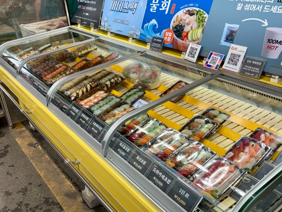 Showcase display of sushi and live fish sashimi