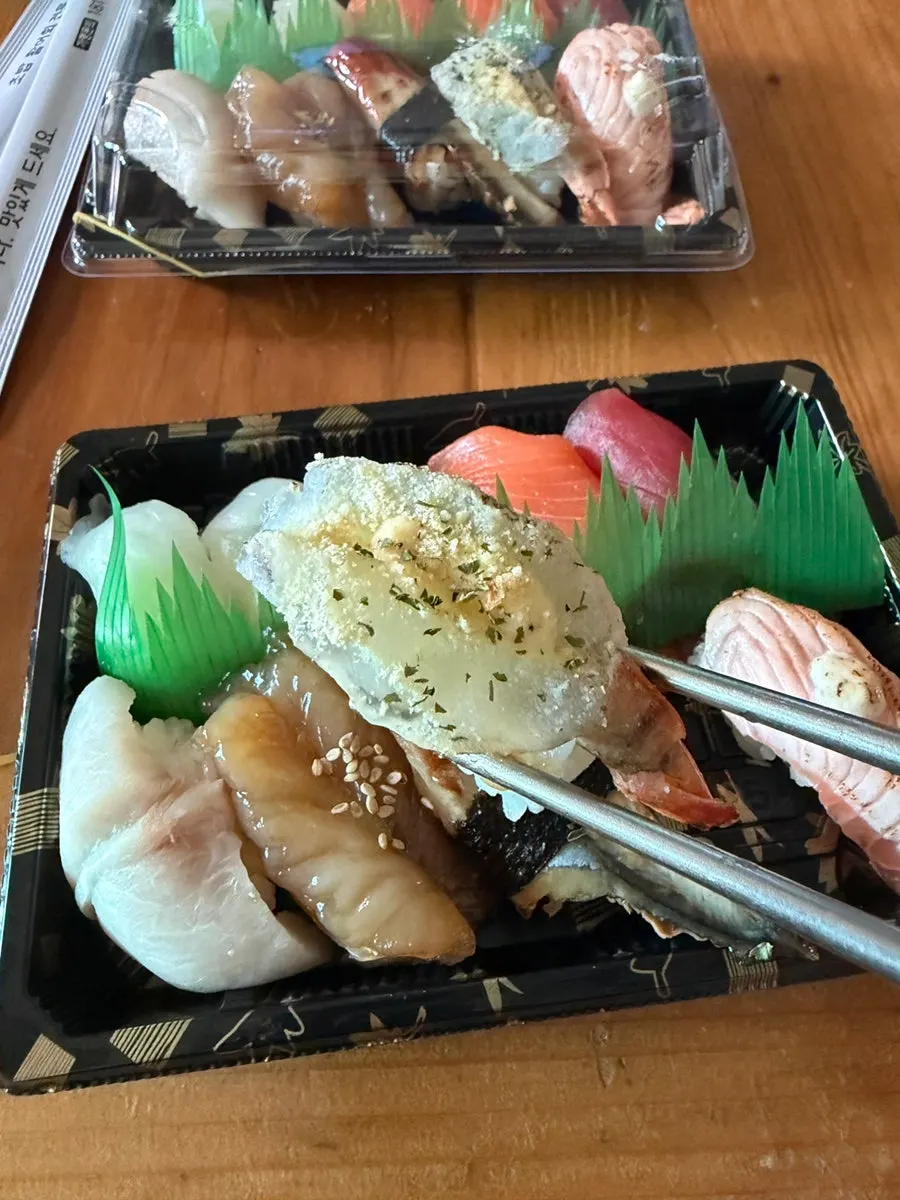 Close-up of special sushi topped with thick cuts of fish