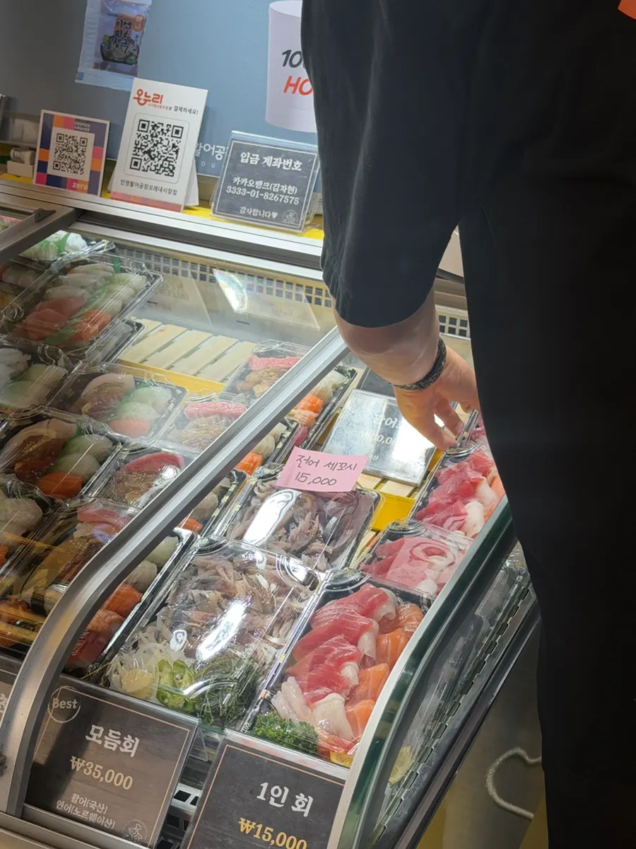 Display case being restocked with sushi