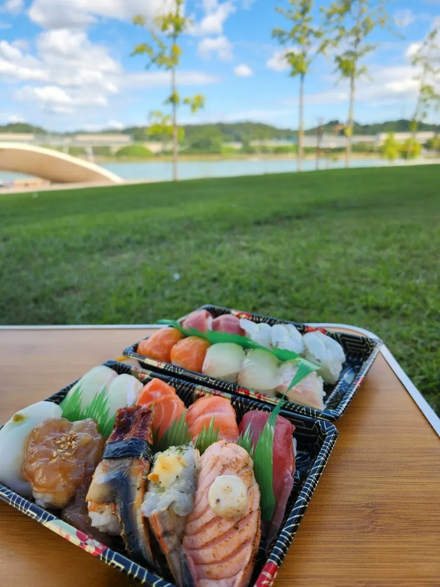Vertical shot of packed sushi from Minyeong Hwareo Gongjang