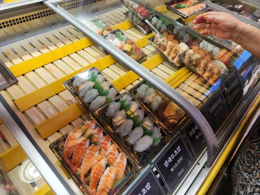 Display case with flounder, salmon, shrimp and other sushi