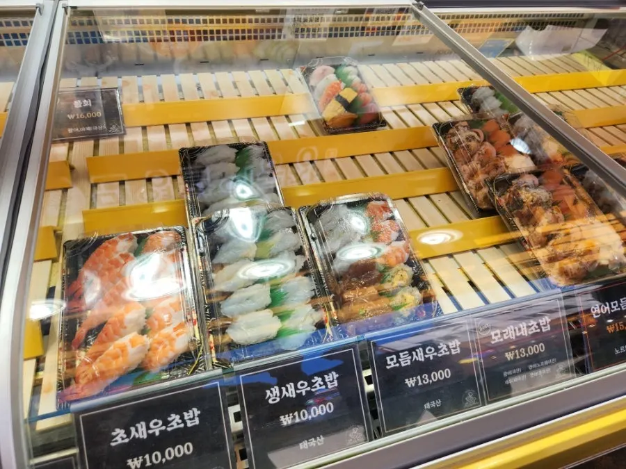 Raw shrimp, vinegared shrimp, and garlic shrimp sushi on display