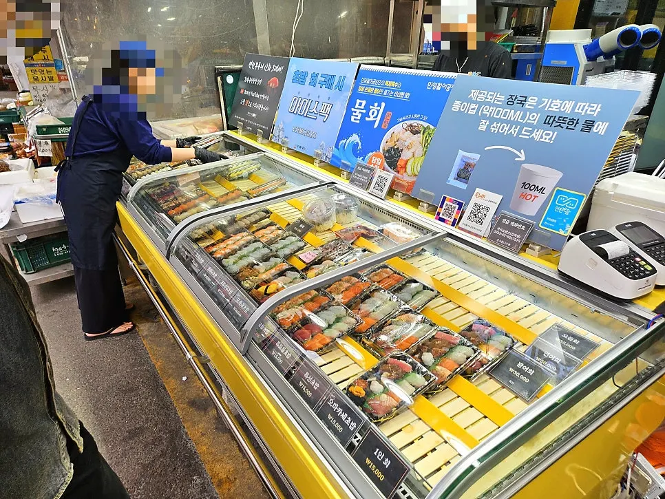 Interior of Minyeong Hwareo with sashimi and sushi on display