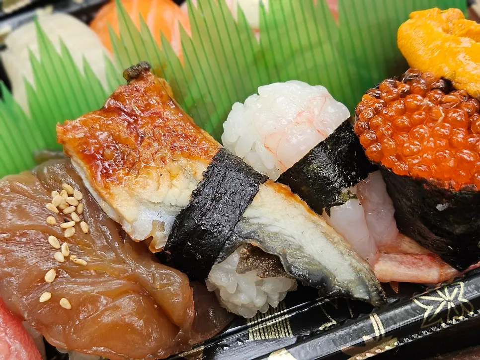 Close-up of sushi including a salmon roe gunkan roll