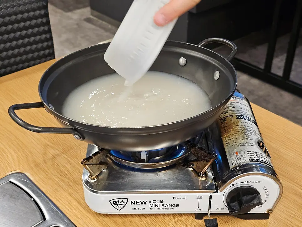 Bone-broth ramyeon boiling on a burner