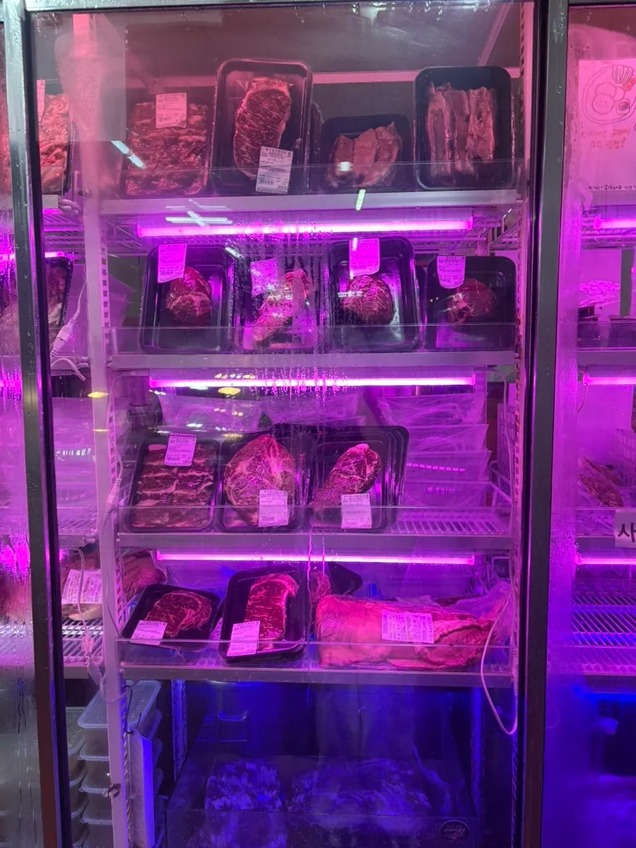 Refrigerator display case inside Morakmorak Home & Cook filled with meat