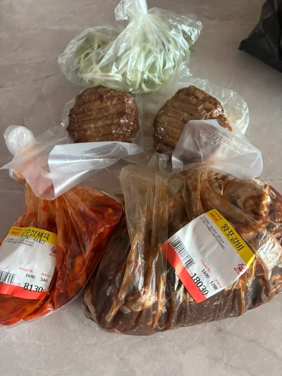 Shopping bag with purchased wangpo galbi, gochujang pork, and tteokgalbi