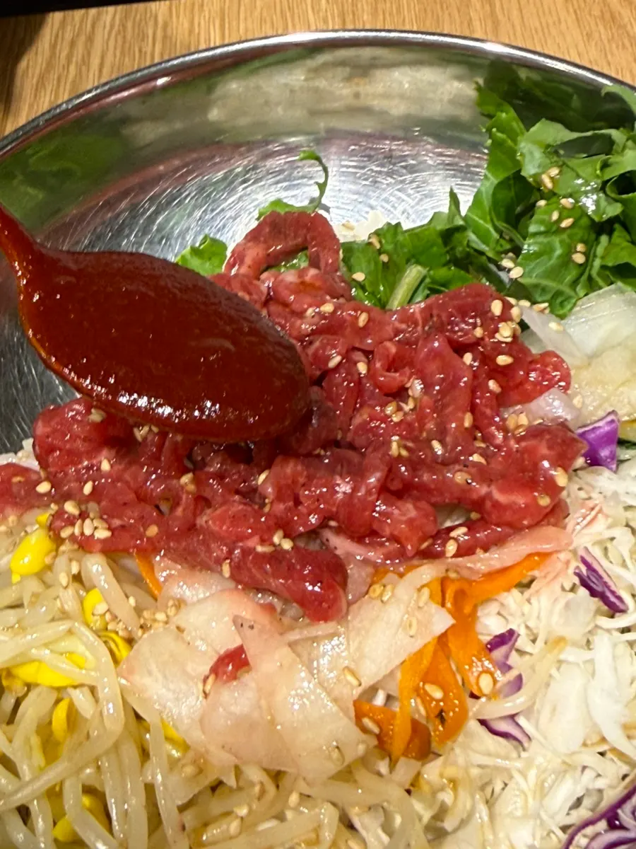 Close-up of the yukhoe bibimbap sprinkled with sesame seeds