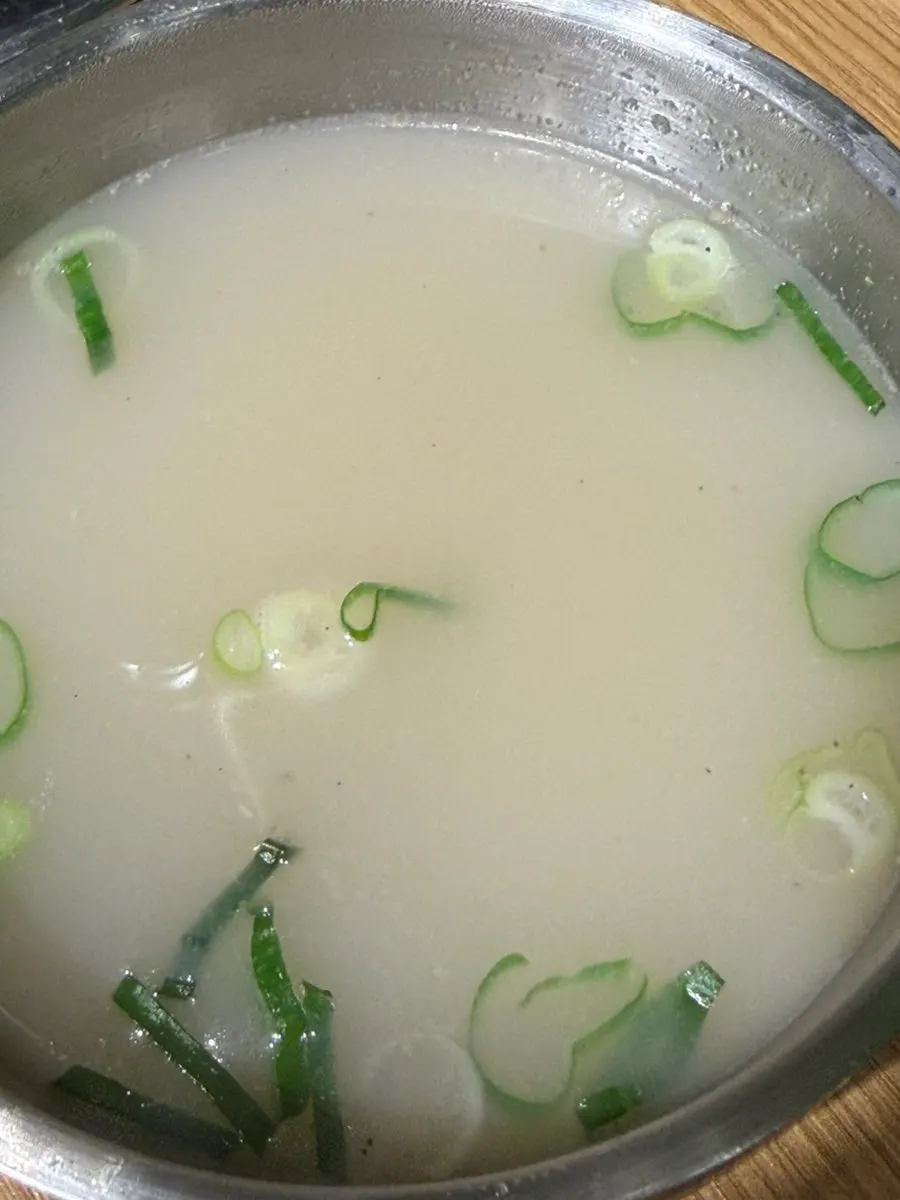 A spoonful of bibimbap with yukhoe and vegetables mixed together