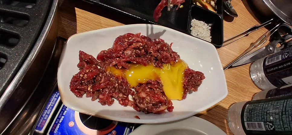 Plate of beef tartare topped with egg yolk