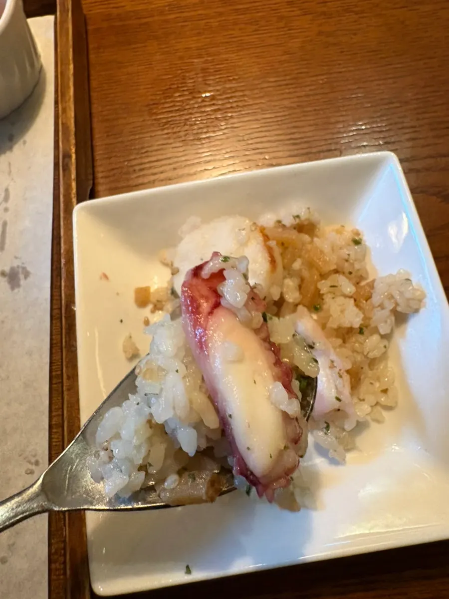 A spoonful of eel sotbap coated in seasoning