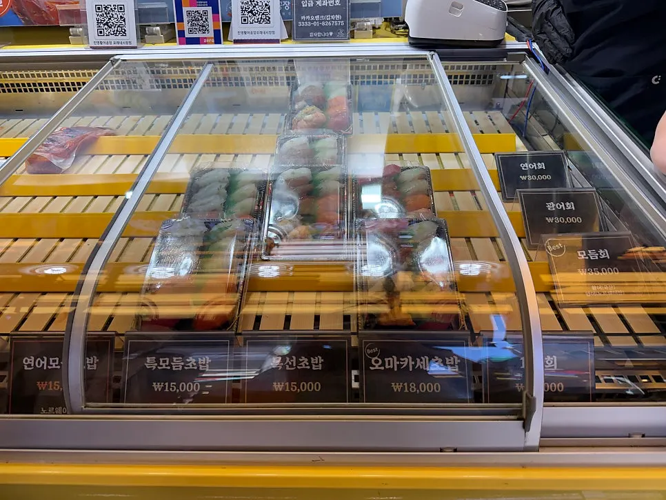 Sushi display case being restocked