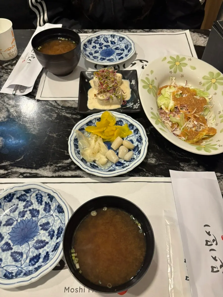 Table set with utensils, wet wipes, and paper cups