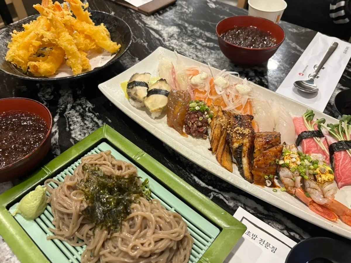 Full table spread with 18-piece sushi, soba, and shrimp tempura