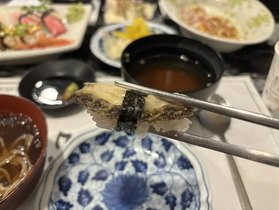 Close-up of halibut fin and abalone sushi