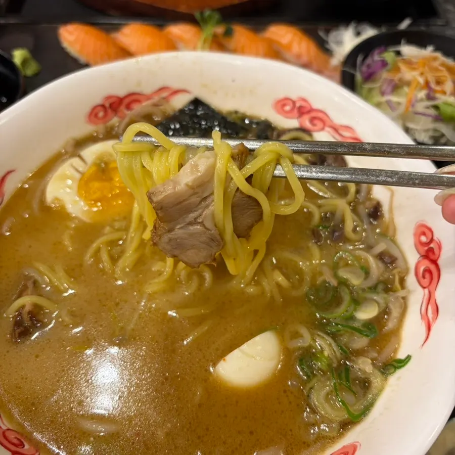 Lifting noodles out of the tonkotsu ramen